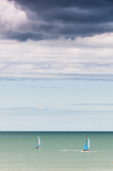 Catamarans sailing off the coast, Brittany France