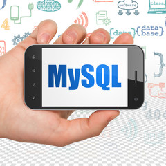 Database concept: Hand Holding Smartphone with MySQL on display