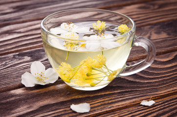 Fototapeta na wymiar Cup of tea with jasmine and linden flower