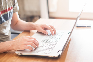 Hands typing on a notebook closeup. Workplace