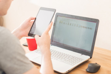 Workplace. Hands holding tablet and notebook closeup
