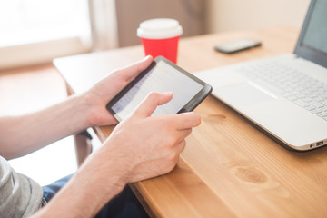 Workplace. Hands holding tablet and notebook closeup