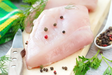 Raw chicken fillet with spices and vegetables