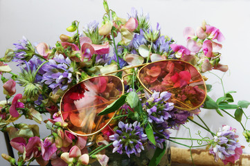 Pink glasses on a bouquet of flowers