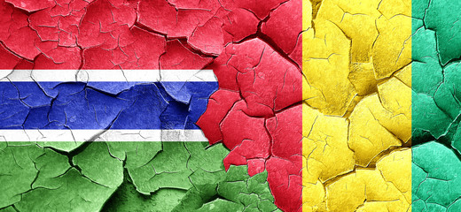 Gambia flag with Guinea flag on a grunge cracked wall