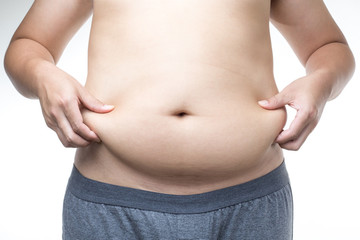 Naklejka premium overweight man with hand holding fat belly