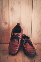 Brown leather shoes on a black wooden floor, Style vintage