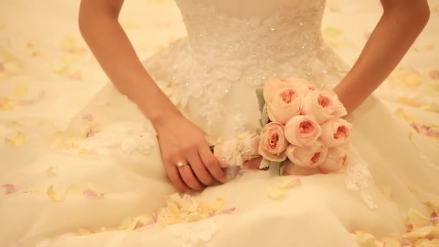 Bride holding wedding bouquet in her hands