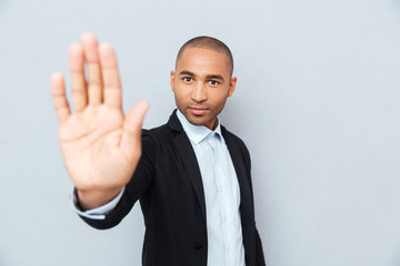 Young african man showing stop sign with hand