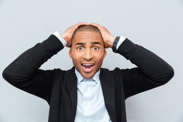 Closeup portrait of unhappy upset guy isolated on gray background