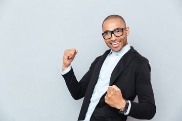Handsome happy african american young man celebrating success