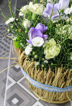 Basket with carnation and freesia flowers.
