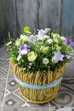 Basket with carnation and freesia flowers.