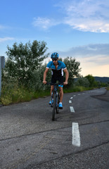 cyclist going mountain bike along a lonely road