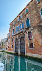 Facade of a red brick house in Venice, Italy