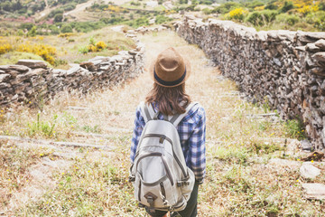 Hiker traveler woman on a hiking trail, travel and active lifestyle concept