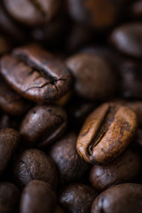 Macro view of roasted coffee beans. Detail shot of coffee beans with selective focus. Shallow depth of field.