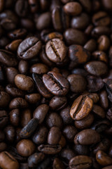 Vertical view of roasted coffee beans. Macro shot of coffee beans with selective focus. Shallow depth of field.