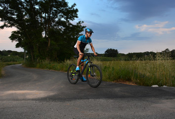 cyclist going mountain bike along a lonely road