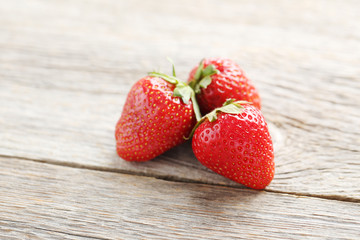 Fresh and tasty strawberries on a grey wooden table