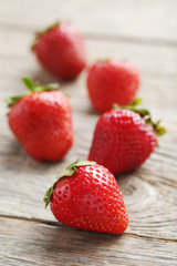 Fresh and tasty strawberries on a grey wooden table