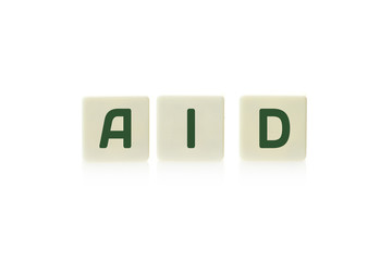 Word "Aid"" on board game square plastic tile pieces, isolated on a white background.