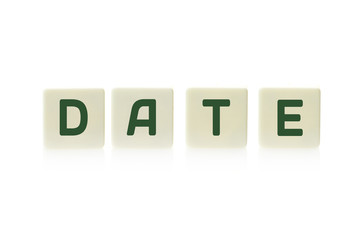 Word "Date" on board game square plastic tile pieces, isolated on a white background.