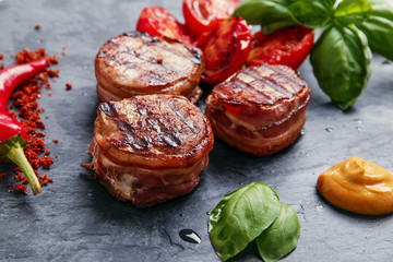 Grilled meat fillet steak wrapped in bacon medallions