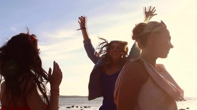 group of happy women or girls dancing on beach 45