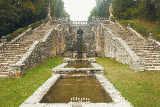 old fountain with a stone staircase of la Roche Courbon in France