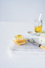Crackers with gorgonzola and herb and white sweet wine  jelly. Selective focus
