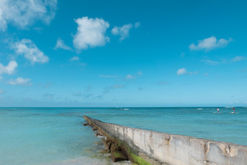 concrete path walk way wall extend to clean blue sea on nice blue cloud sky vacation day. relaxing place for travel on weekend.
