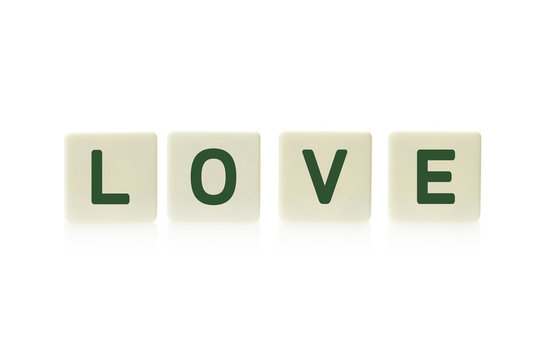 Word "Love" on board game square plastic tile pieces, isolated on a white background.