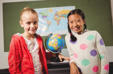Girls standing in front of blackboard