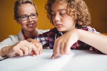 Boy using braille to read