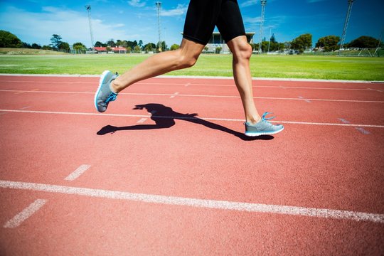 Female Athlete Running On The Running Track