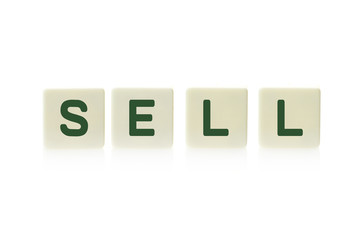 Word "Sell" on board game square plastic tile pieces, isolated on a white background.