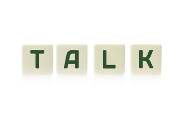 Word "Talk" on board game square plastic tile pieces, isolated on a white background.