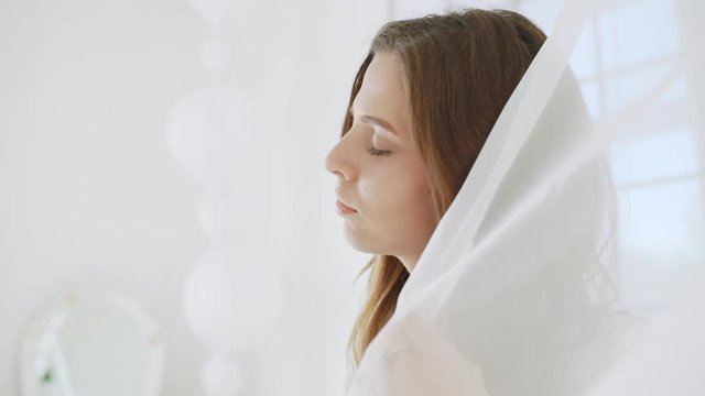 Young beautiful girl in white decor. Slow motion.
