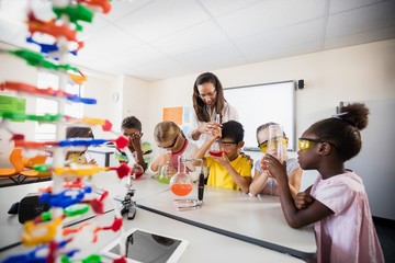 Pupils doing science with a teacher