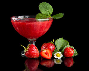 Fresh strawberries with goblet,leaves,flower on black