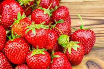 Group of ripe, organic strawberry on wooden table