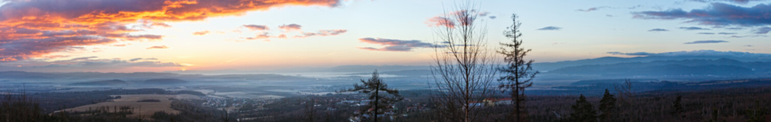 Clouds illuminated by morning sun over valley.