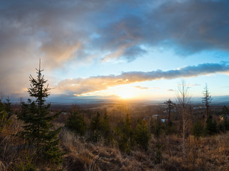 Clouds illuminated by morning sun over valley.