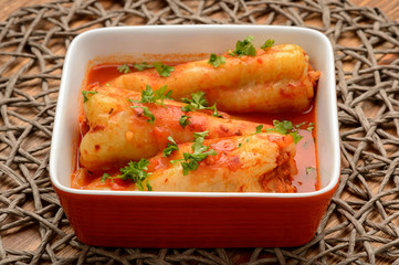 Stuffed peppers baked with tomato sauce.