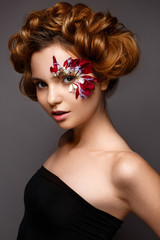 Beautiful girl with creative make-up with floral appliques. The model in the style of romantic with...