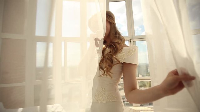 Beautiful young bride in white wedding dress indoors