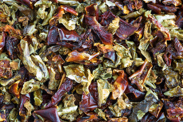 Close view of dried red and green bell peppers.