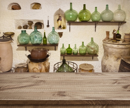 Textured wooden planks table over ancient cave kitchen interior background