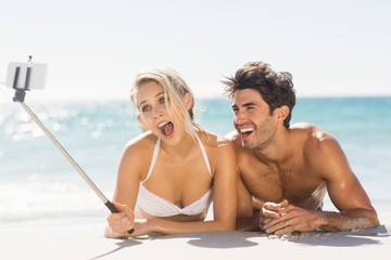 Fototapeta premium Young couple taking selfie on beach